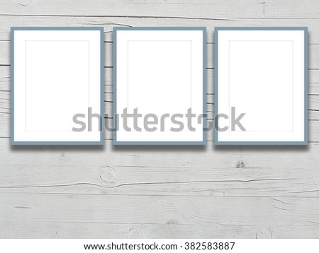Close-up of three aqua picture frames on light grey wooden boards background