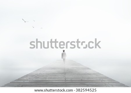 Man disappearing in the white fog Royalty-Free Stock Photo #382594525