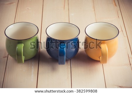 Mugs on wooden background