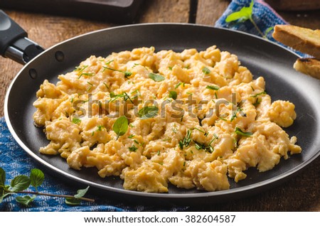 Scrambled eggs rustic style, with toast and herbs