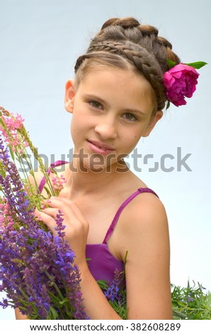 Teenage girl with hairstyle  and a pion and wildflowers