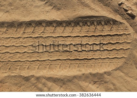Wheel tracks on sandy background. Copy space texture