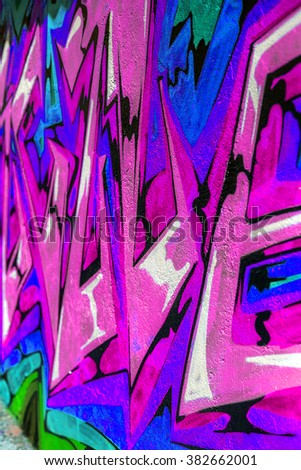 Beautiful street art of graffiti. Abstract color creative drawing fashion on walls of city. Urban contemporary culture. Original dot pattern with selective focus in the future. Creative design option