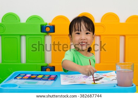 Asian Little Chinese Girl Washing Painting Brush in Water