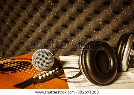 microphone,headphone,lyric on classic guitar  background in home