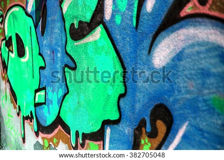 Beautiful street art of graffiti. Abstract color creative drawing fashion on the walls of city. Urban contemporary culture. Original dot pattern with selective focus in future. Creative design option