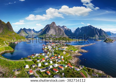 Reine, Lofoten, Norway. The village of Reine under a sunny, blue sky, with the typical rorbu houses. View from the top Royalty-Free Stock Photo #382716112