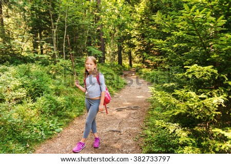 Little hiker girl in forest. Photo from Champex-Lac, Valais, swiss Alps