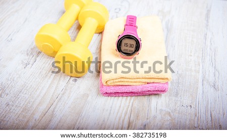 fitness - dumbbells and concept sports watch