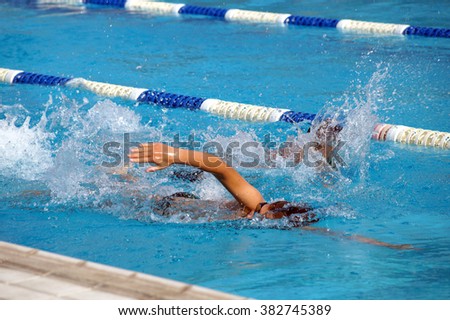 Heat of children on one path in the swimming pool Royalty-Free Stock Photo #382745389