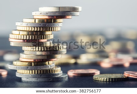 Euro coins stacked on each other in different positions.