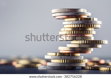 Euro coins stacked on each other in different positions. Royalty-Free Stock Photo #382756228