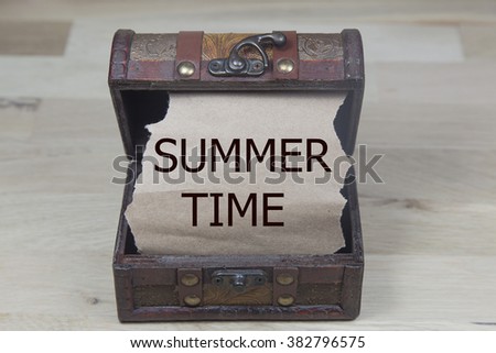 summer time is written on the Brown torn paper in the treasure box. holiday concepts. 