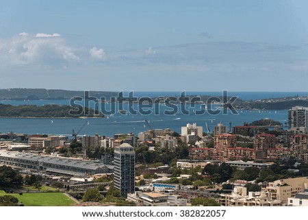 Sydney harbor with ships and yachts and adjacent buildings from height