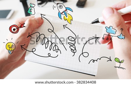 Mans hand drawing Arrows with cartoon on white notebook 