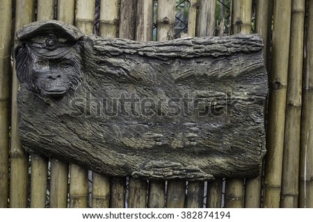 blank rock advertising with monkey face on a bamboo background
