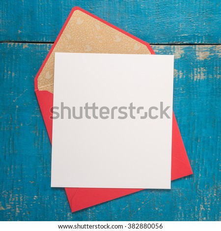 Blank paper and envelope on wooden background 
