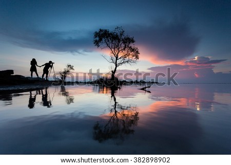 silhouette of photographer taking picture of landscape.