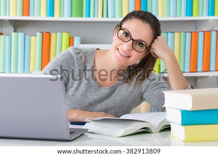 Photo Of Happy Young Woman Studying In Library