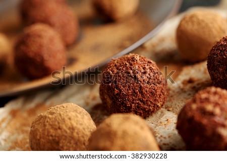 Sweet chocolate truffle on a black wooden table