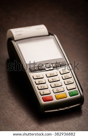 Color image of a POS and credit cards.