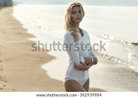 Closeup portrait of a tanned blond lady in tropics