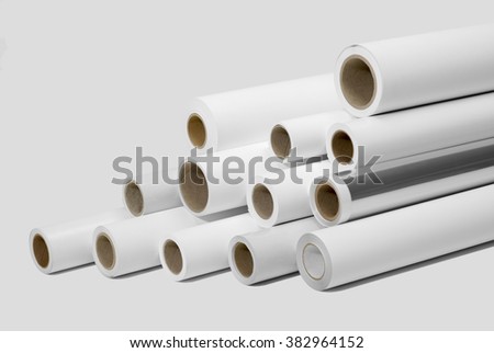 various print media rolls for wide-format printers in light grey back Royalty-Free Stock Photo #382964152
