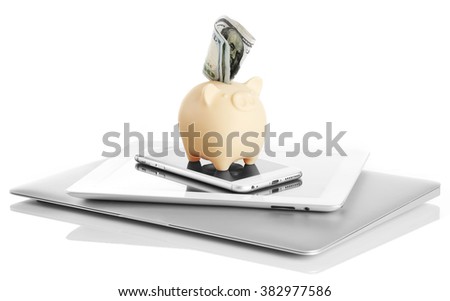 Piggy bank on modern devices with dollars isolated on white