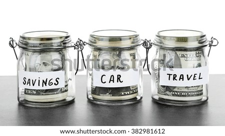 Three jars for different needs full of banknotes