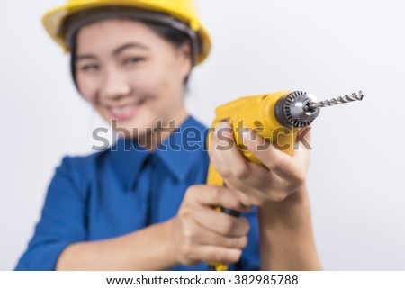 Young builder woman with a drill