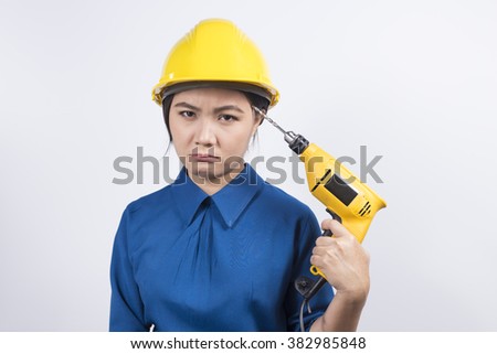 Young builder woman with a drill