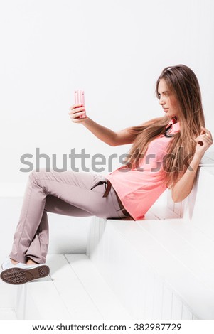 girl doing selfie on mobile phone