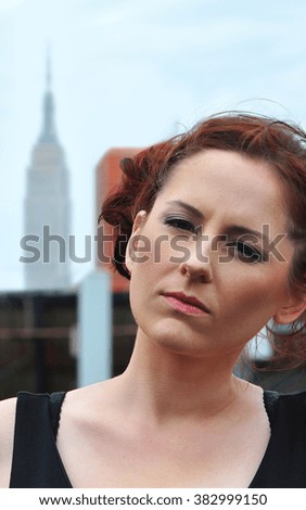 Manhattan, New York, USA - June 20, 2014: model looking at the camera on rooftop
