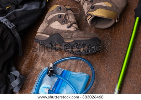 Closeup shot of various tools and equipment for a hiker laid out on a table