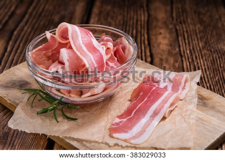 Portion of raw Bacon stripes on wooden background (selective focus) Royalty-Free Stock Photo #383029033