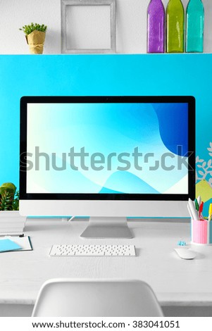 Stylish workplace with computer and interior decorations