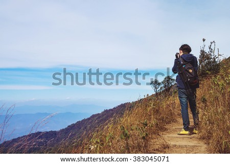 Vintage photo of photographer is taking a picture in mountains