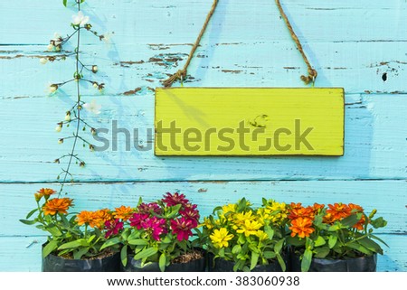 Wooden signboard on wooden wall with flower. vintage style.