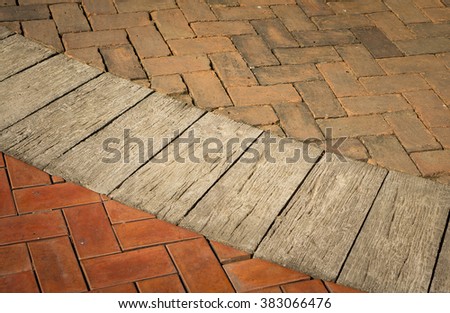 Brick floor and paving stones on a sidewalk.
