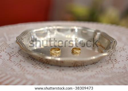 Two golden wedding rings on the plate