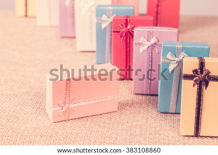 Small gift box set on sack cloth background,vintage tone