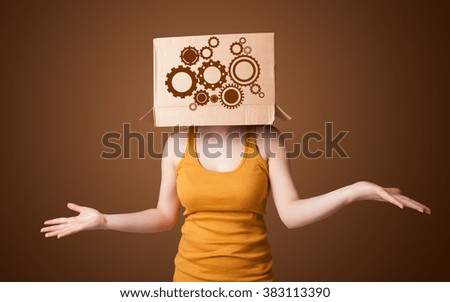 Young woman standing and gesturing with a cardboard box on his head with spur wheels