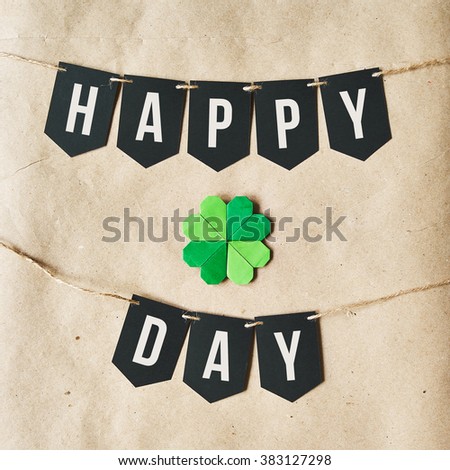 HAPPY ST. PATRICK'S DAY black banner lettering on eco craft paper background. Holiday greeting postcard template.