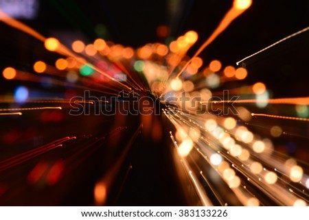 Night traffic in the city, car lights in motion blur with zoom effect