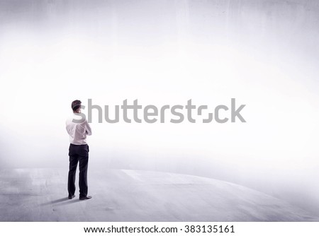 Young sales businessman in elegant suit standing with his back in empty white space background concept