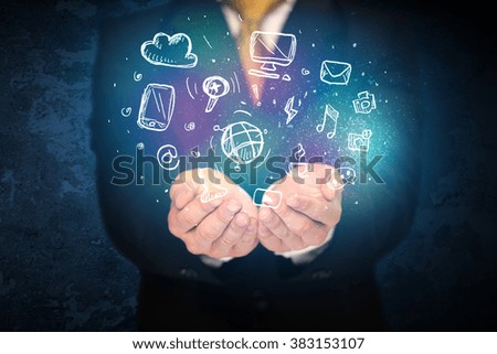 Businessman holding hand drawn media icons