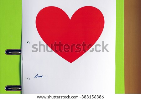 red heart on white paper with love word