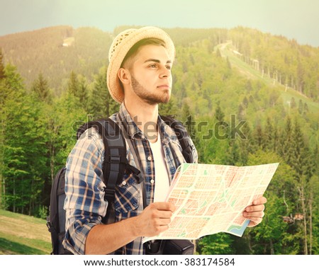Traveler with map on nature background