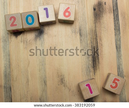 Cubes with numbers on wooden background