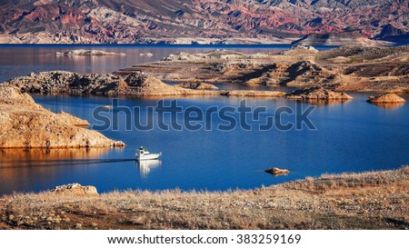 A powerboat cruising on Lake Mead Royalty-Free Stock Photo #383259169